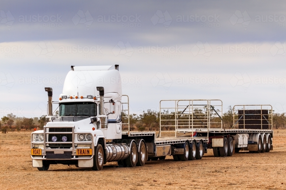 Semi trailer road train sits empty under a leaden sky. - Australian Stock Image