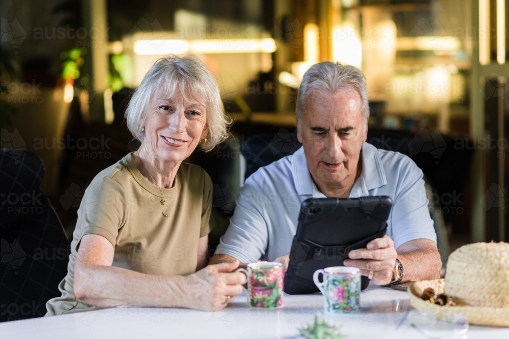 senior couple using ipad at home - Australian Stock Image