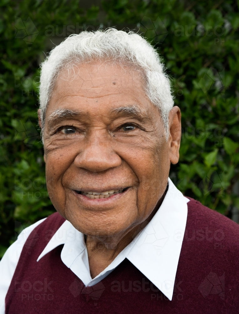 Senior man with Indonesian heritage smiles in profile photo. - Australian Stock Image