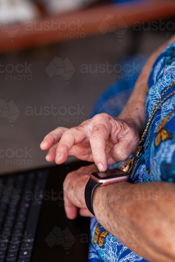 senior person using smartwatch technology - Australian Stock Image