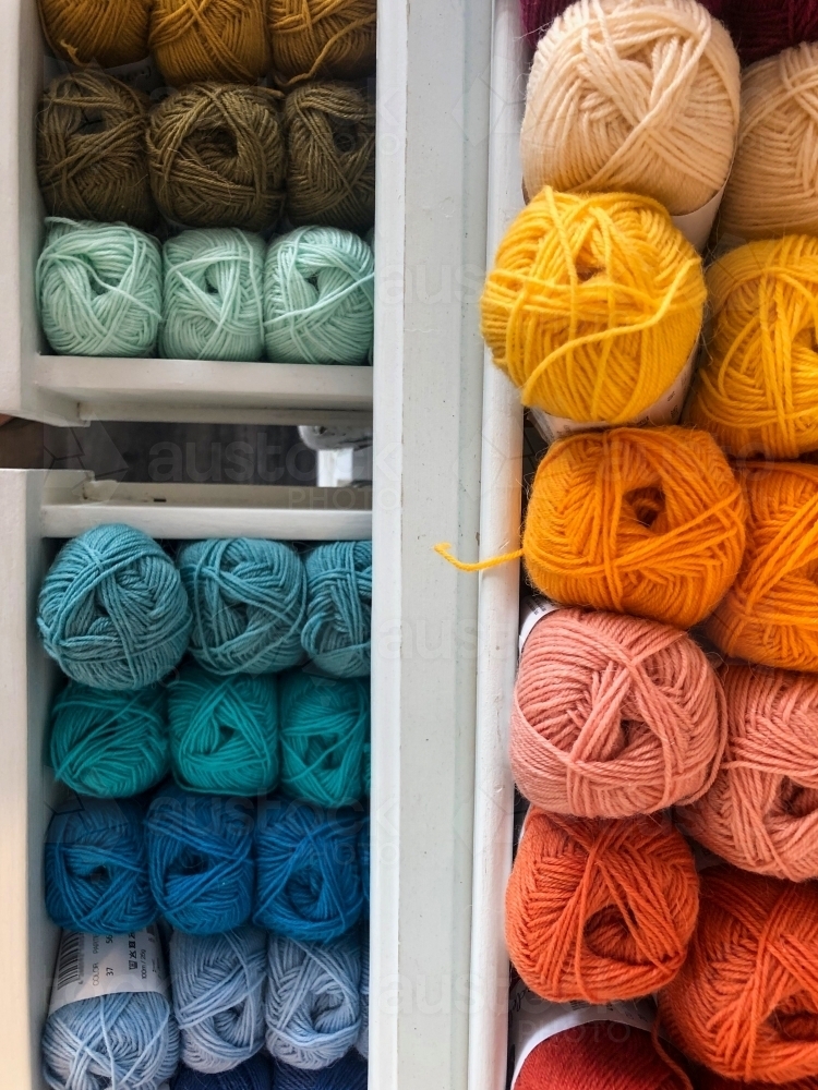 Sets of colourful skein yarn stacked in cubicles. - Australian Stock Image