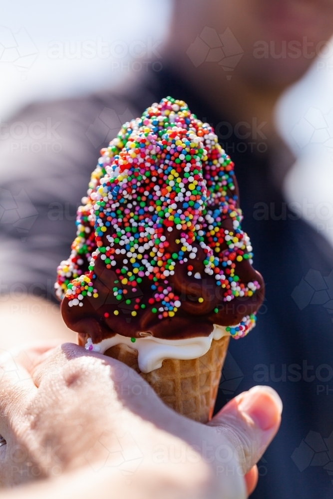 sharing ice cream dessert outdoors on summers day - Australian Stock Image