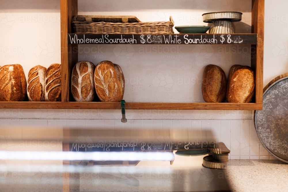 Shelf with bread loaves in a bakery - Australian Stock Image