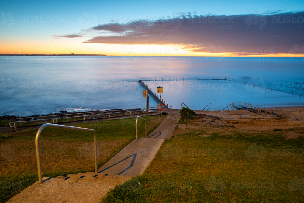 Shelly Park ocean pool and walkway at sunrise - Australian Stock Image