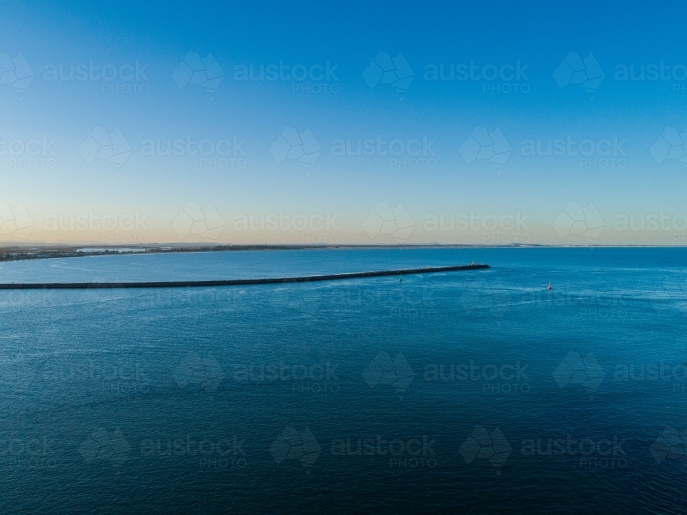 Shipwreck Walk breakwater Stockton seen over water from Nobbys - Australian Stock Image