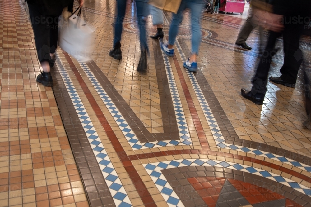 Shoppers walking on tiled floor - Australian Stock Image