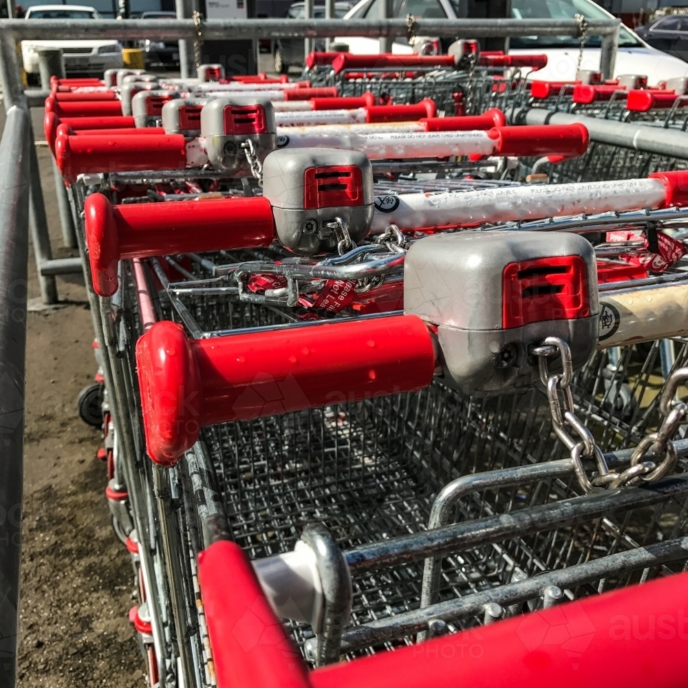 Image of Shopping trolleys chained together - Austockphoto