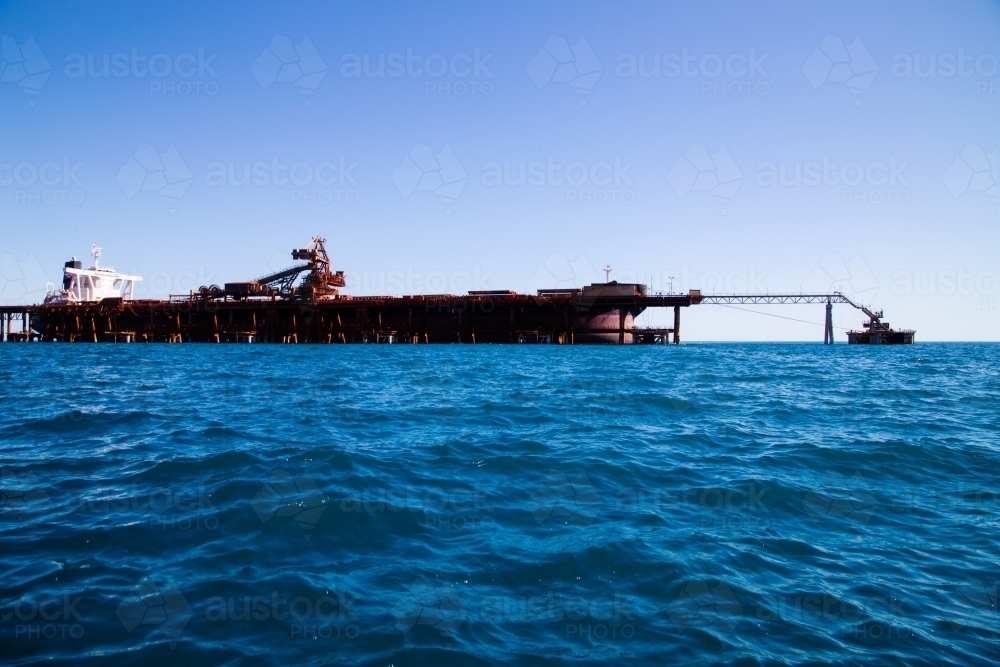Side view of freight ship docked for loading - Australian Stock Image