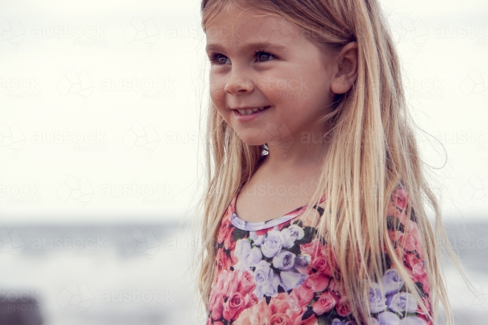 Side view of young girl on beach - Australian Stock Image