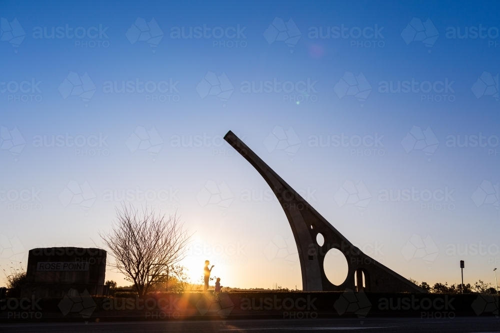 Silhouette sundial in singleton with tourist mother and child - Australian Stock Image