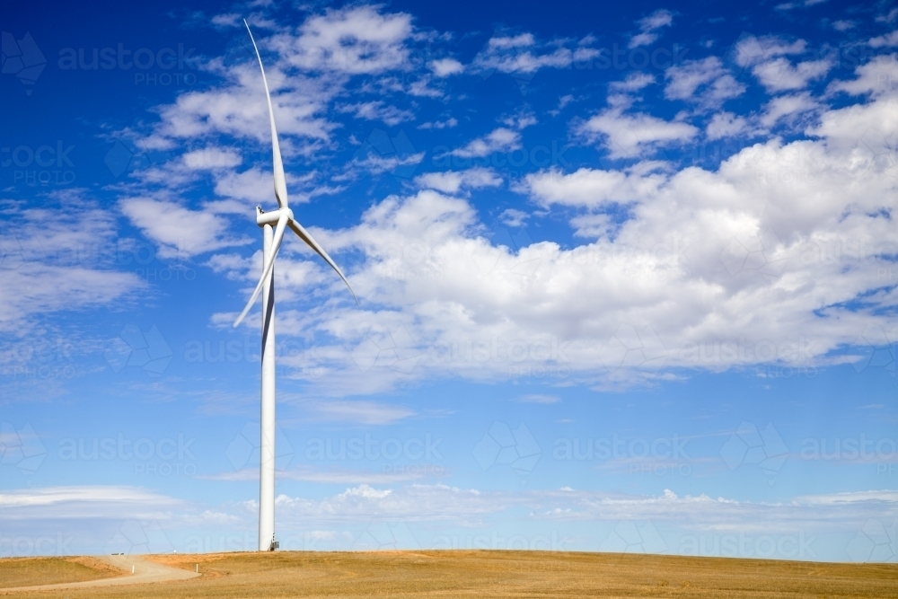 Single wind tower on hilltop - Australian Stock Image