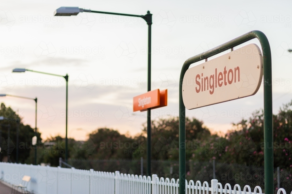 Singleton train station sign in dawn light at early commute - Australian Stock Image