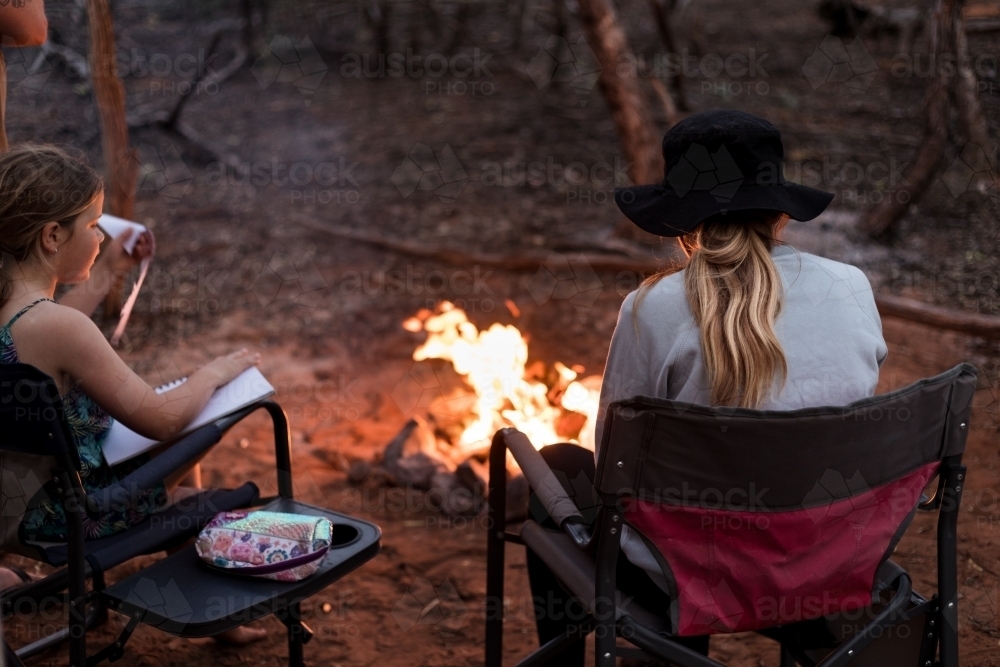 Sisters by the camp fire - Australian Stock Image