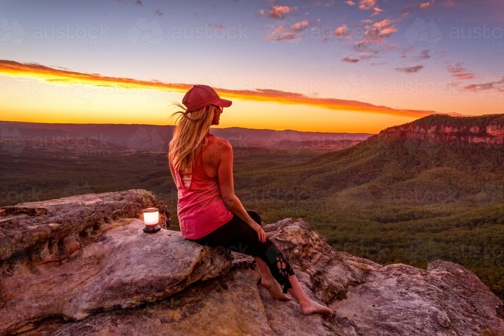 Sitting quietly watching the sunset from clifftops in the Blue Mountains - Australian Stock Image