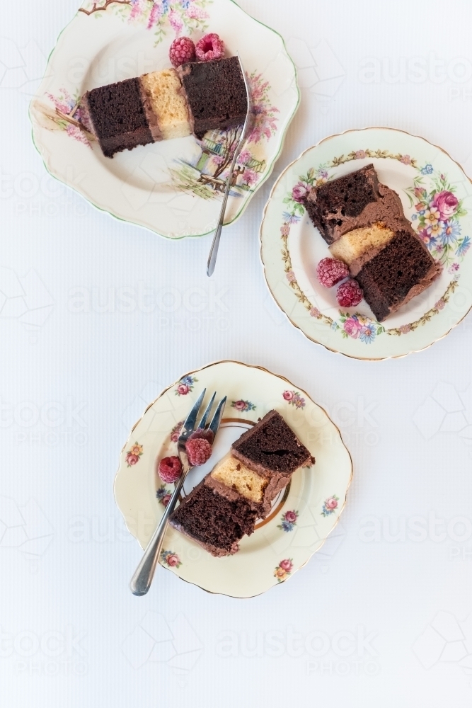 Slices of cake on antique plates from above. - Australian Stock Image