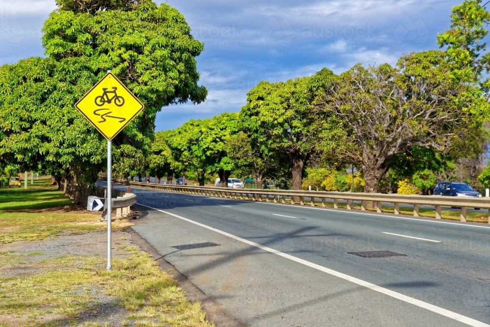 Slippery road warning sign for push bikes and cars driving on sealed roads in suburban areas - Australian Stock Image