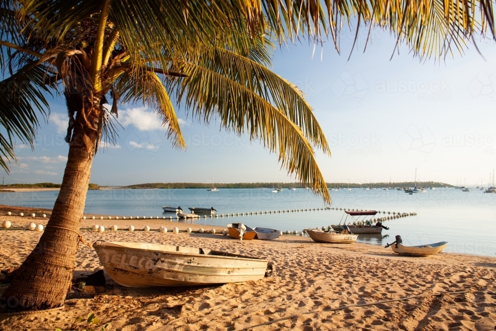 Small boats on the beach as the sun sets at the Gove Yacht Club. - Australian Stock Image