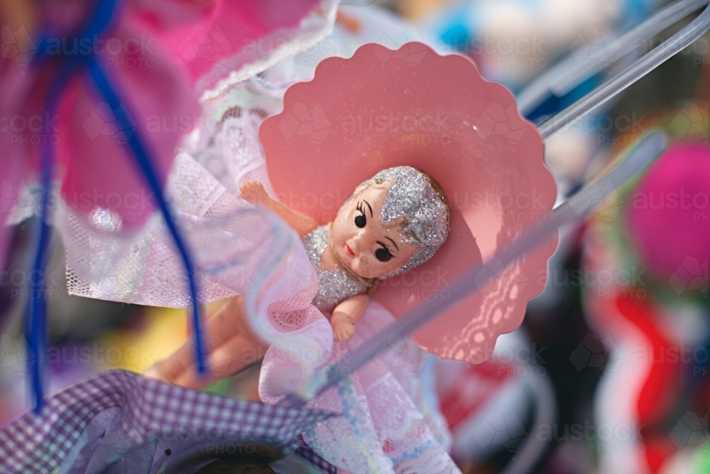 Small figurine doll wearing a pink lacy dress - Australian Stock Image