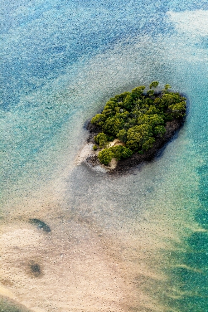 small island in patterned sea - Australian Stock Image