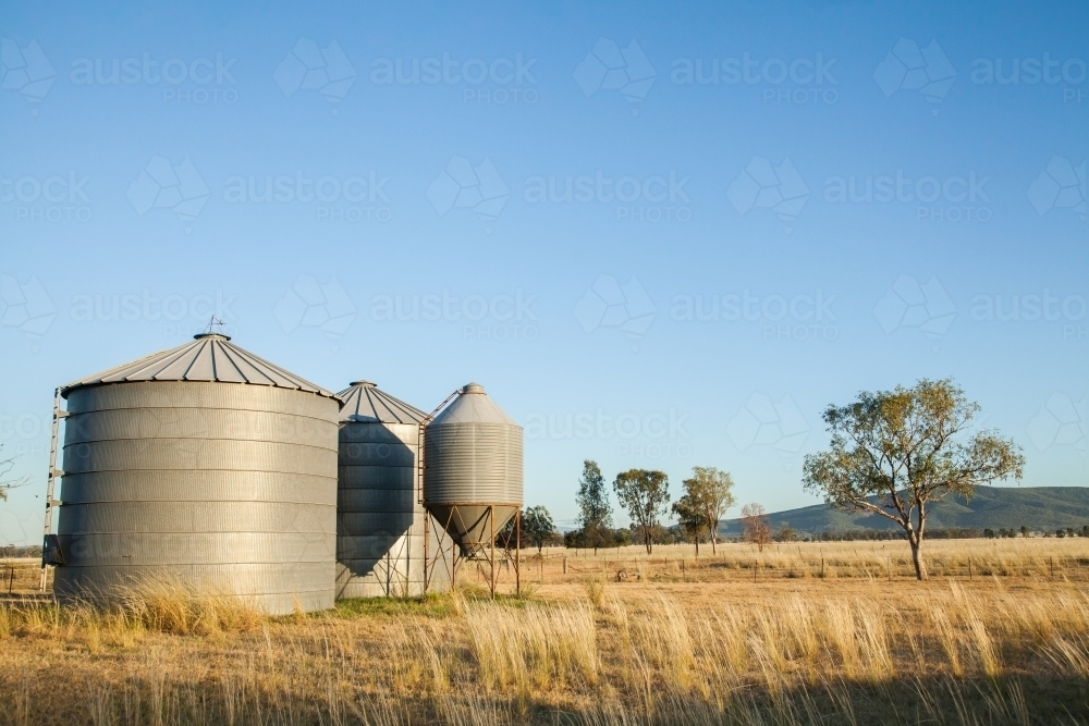 Small metal grain silos on rural farm property - Australian Stock Image