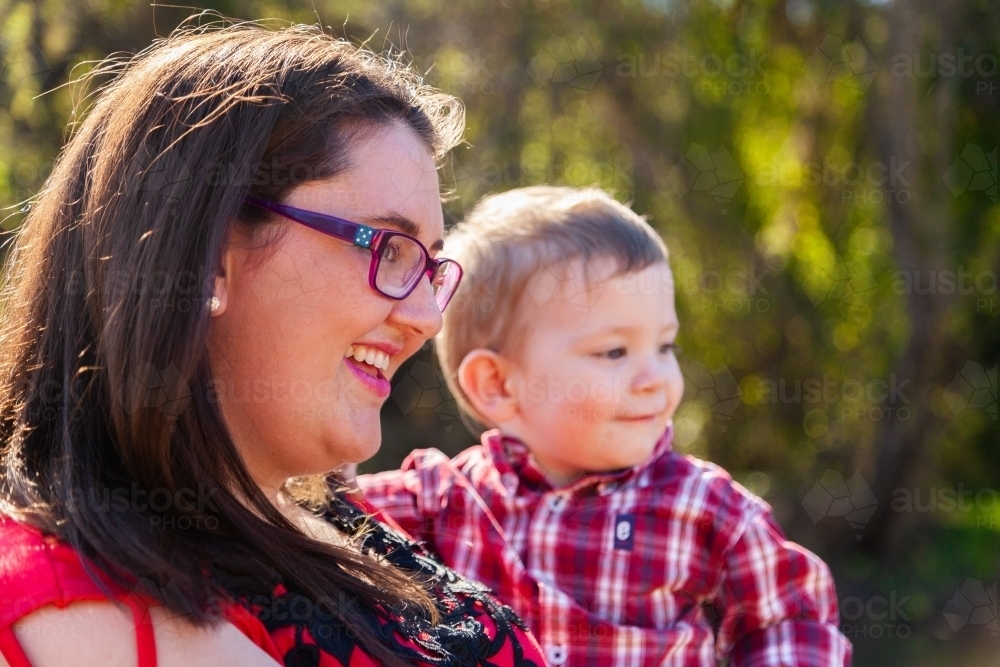 Smiling mother holding young son - Australian Stock Image