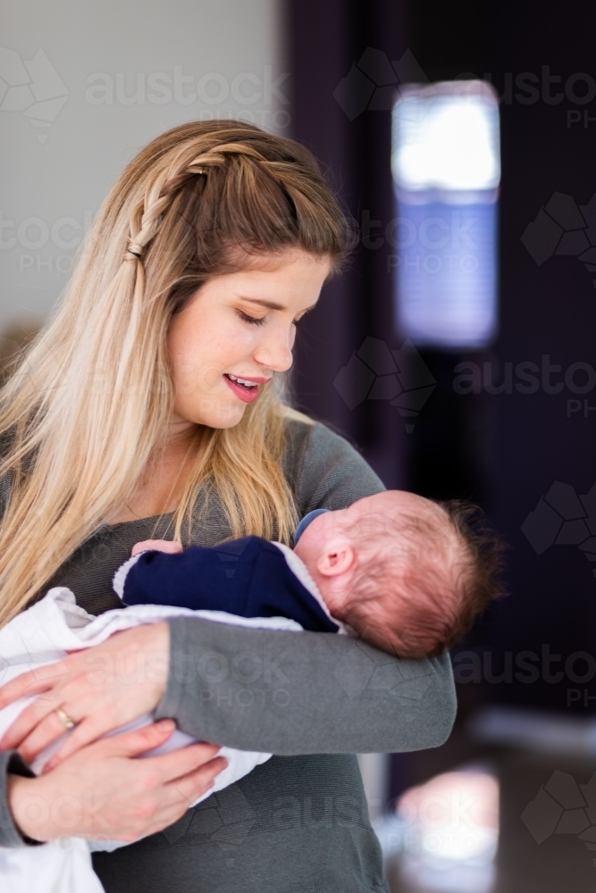 Smiling mother with newborn - Australian Stock Image