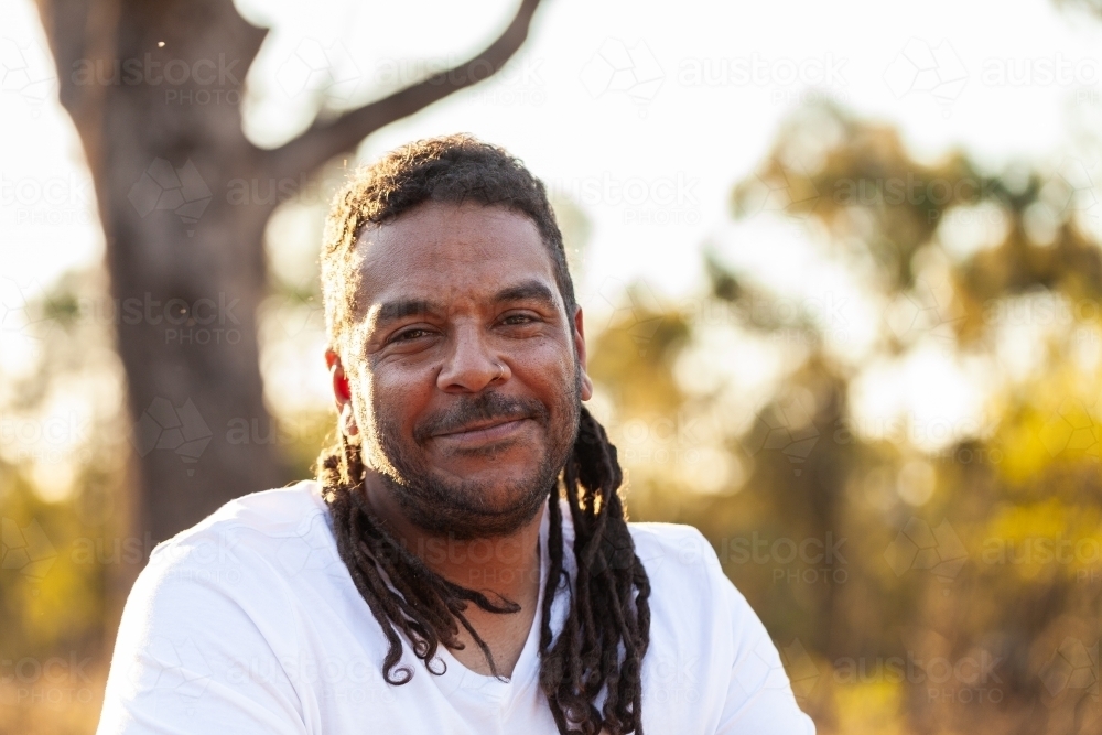 Smiling portrait of happy aboriginal man in his late thirties - Australian Stock Image