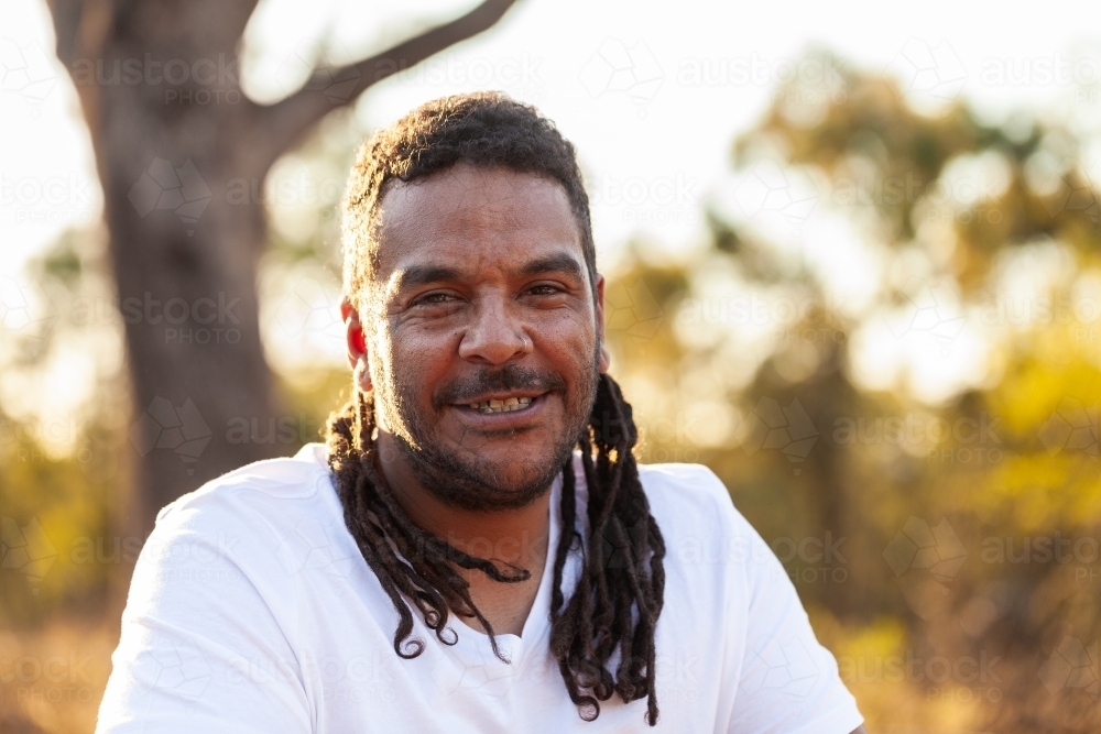 Smiling portrait of happy aboriginal man in his late thirties - Australian Stock Image