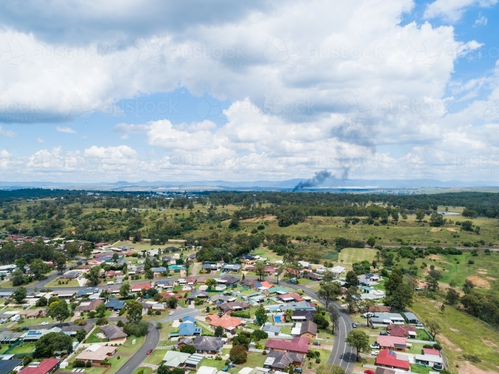 Smoke on horizon from distant house fire outside of town - Australian Stock Image