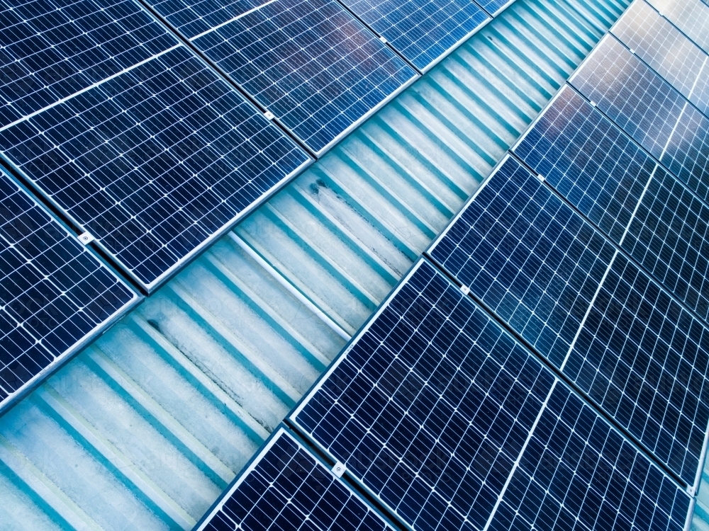 Solar panels installed on shed roof in country - Australian Stock Image