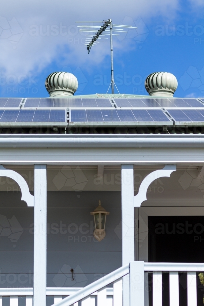 Solar panels, tv antenna, and two rooftop whirlybirds. - Australian Stock Image