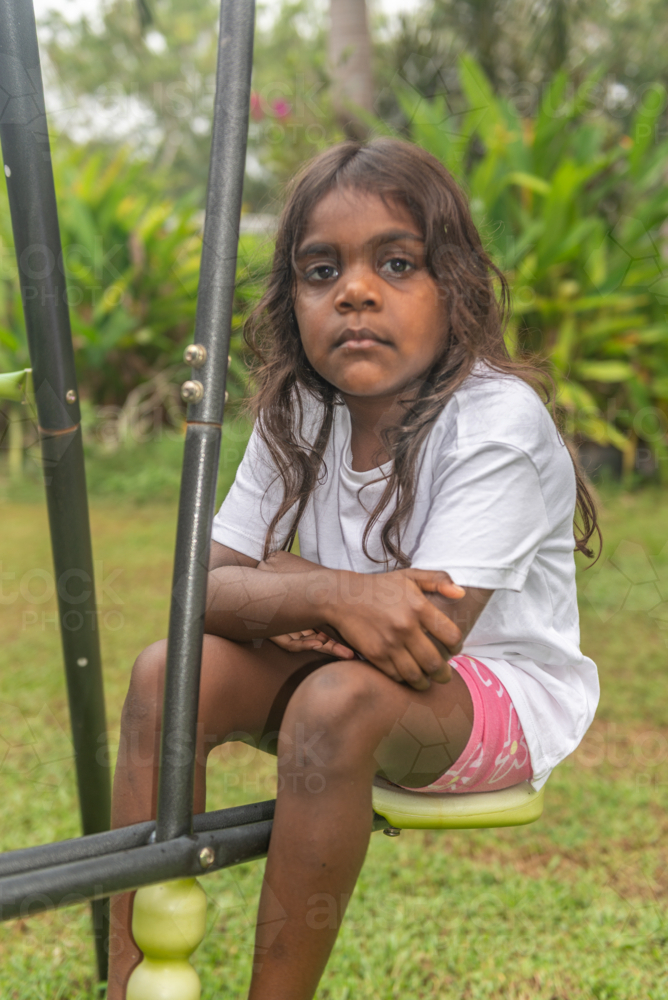 Sore 4 yo aboriginal child daydreaming - Australian Stock Image