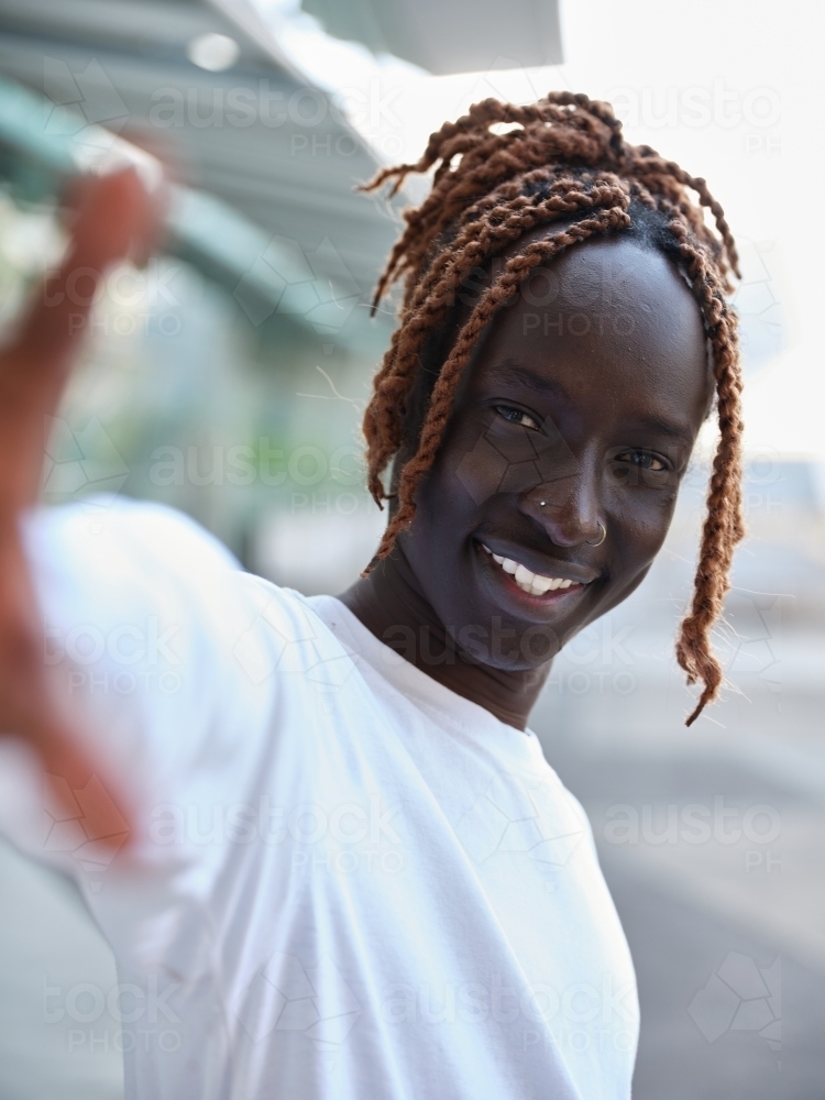 South Sudanese man reaching palm towards the camera - Australian Stock Image