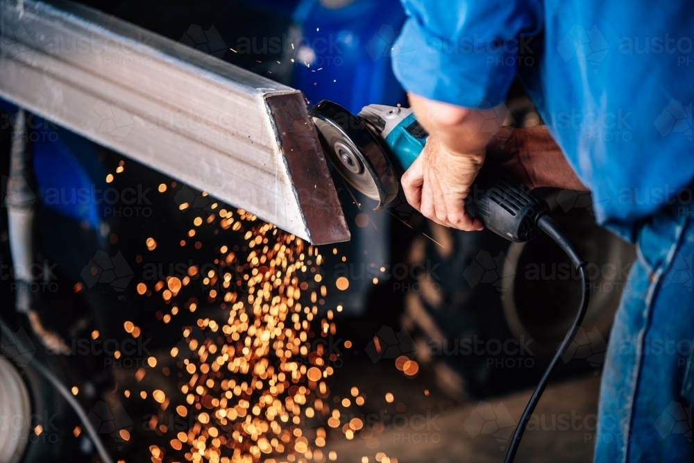 Sparks flying from a grinder grinding steel - Australian Stock Image