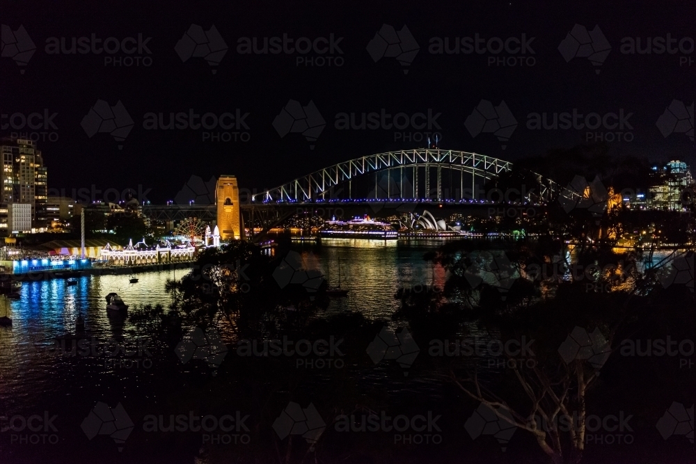 Spectacular view of Sydney Harbour Bridge at night with passenger liner and Sydney Opera House. - Australian Stock Image