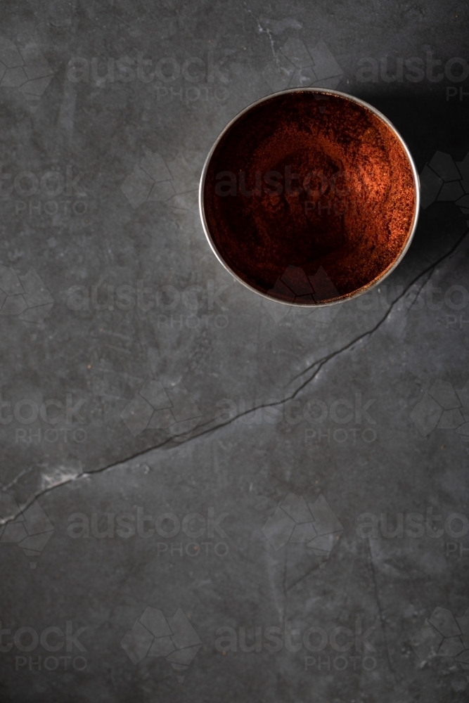 Spice tin of paprika on dark marble background - Australian Stock Image