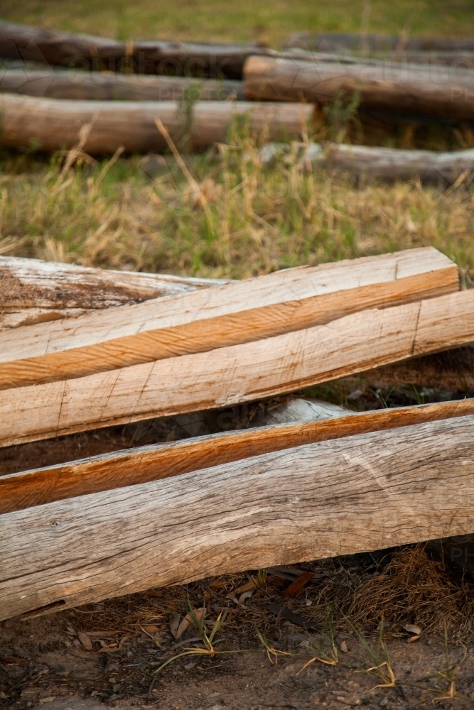 Split logs for fence posts on a farm - Australian Stock Image