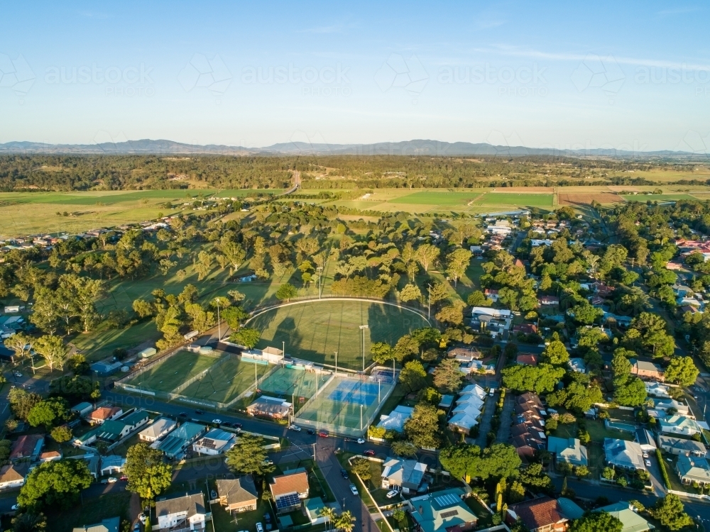 Sports ground, tennis club and football oval beside golf course at edge of town of Singleton - Australian Stock Image