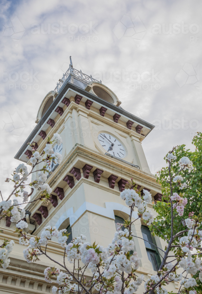 Spring blooms framing an old country post office underneath cloudy skies - Australian Stock Image
