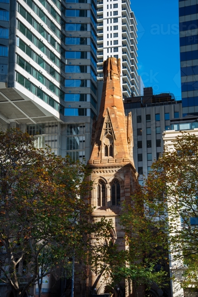 St George's Church sandstone spire surrounded by modern buildings - Australian Stock Image