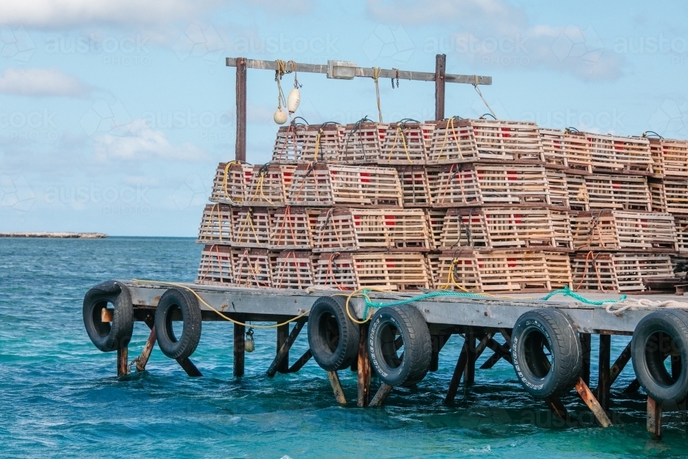 Stacks of craypots on a wooden jetty - Australian Stock Image