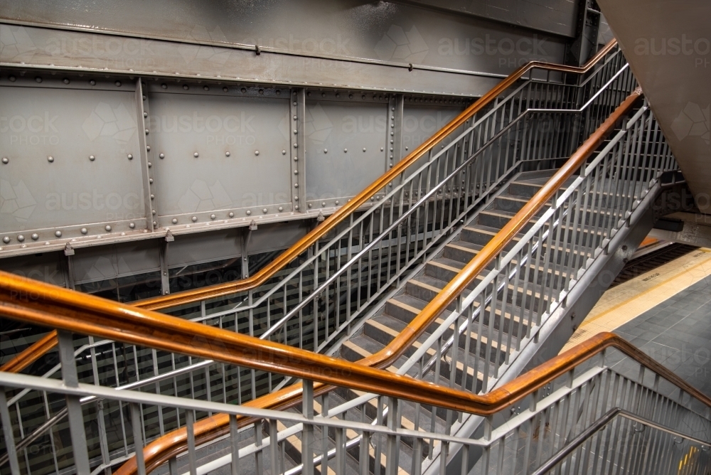 Stairs with wooden handrails in the underground train system in Sydney - Australian Stock Image