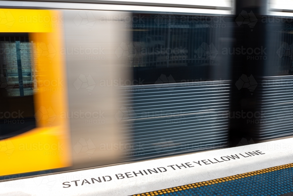 Stand behind the yellow line - Australian Stock Image