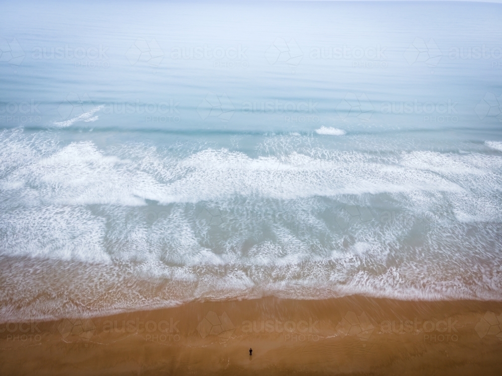 Standing alone on a misty beach - Aerial Perspective - Australian Stock Image