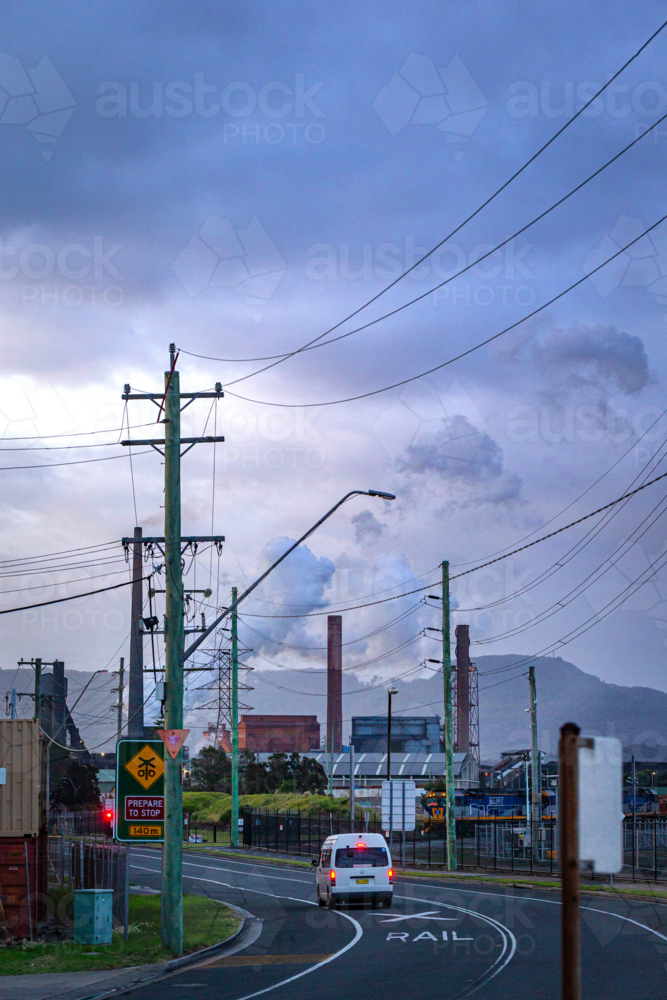Steel Smelter behind power lines and poles - Australian Stock Image