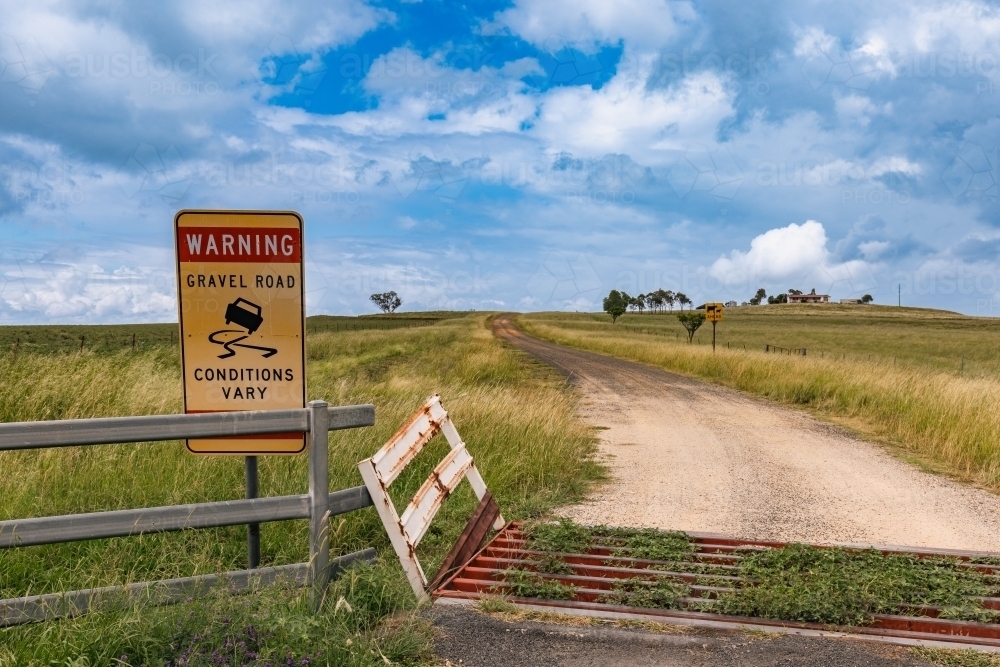 Stock grate across beginning of gravel road in remote rural area - Australian Stock Image