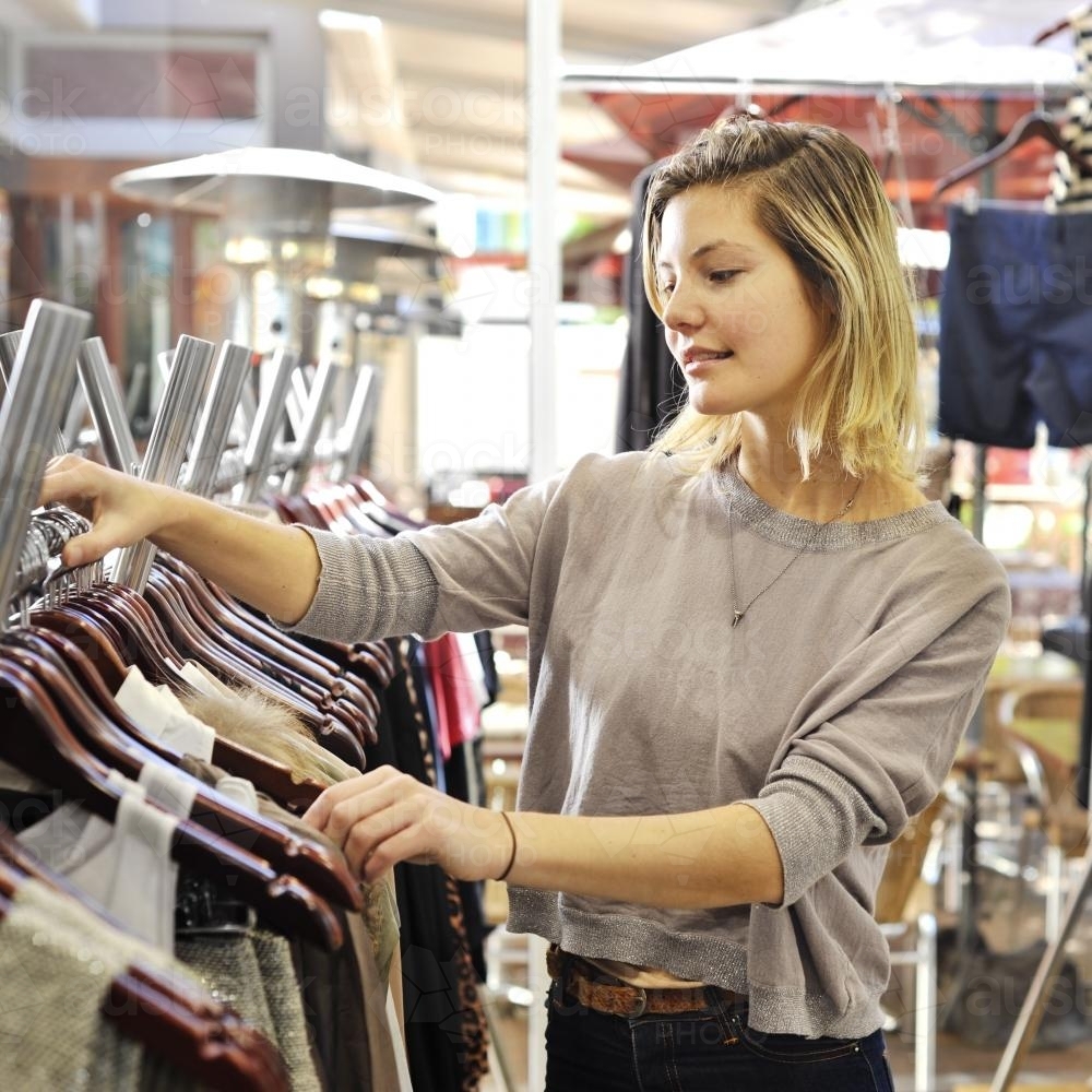 young woman browsing in a clothing boutique