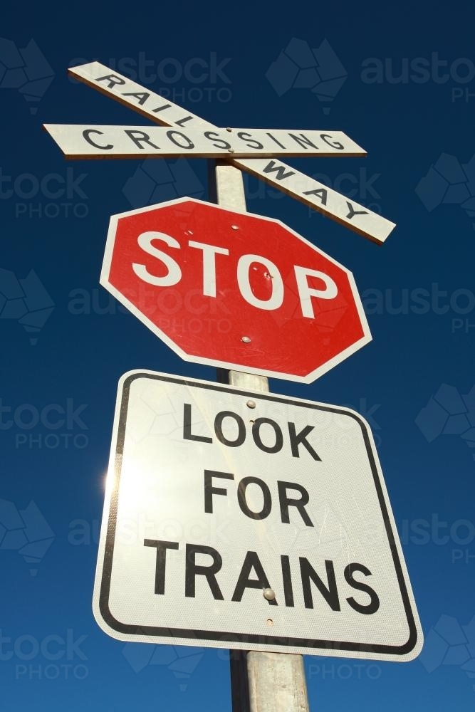 Stop sign - Look for trains against blue sky - Australian Stock Image