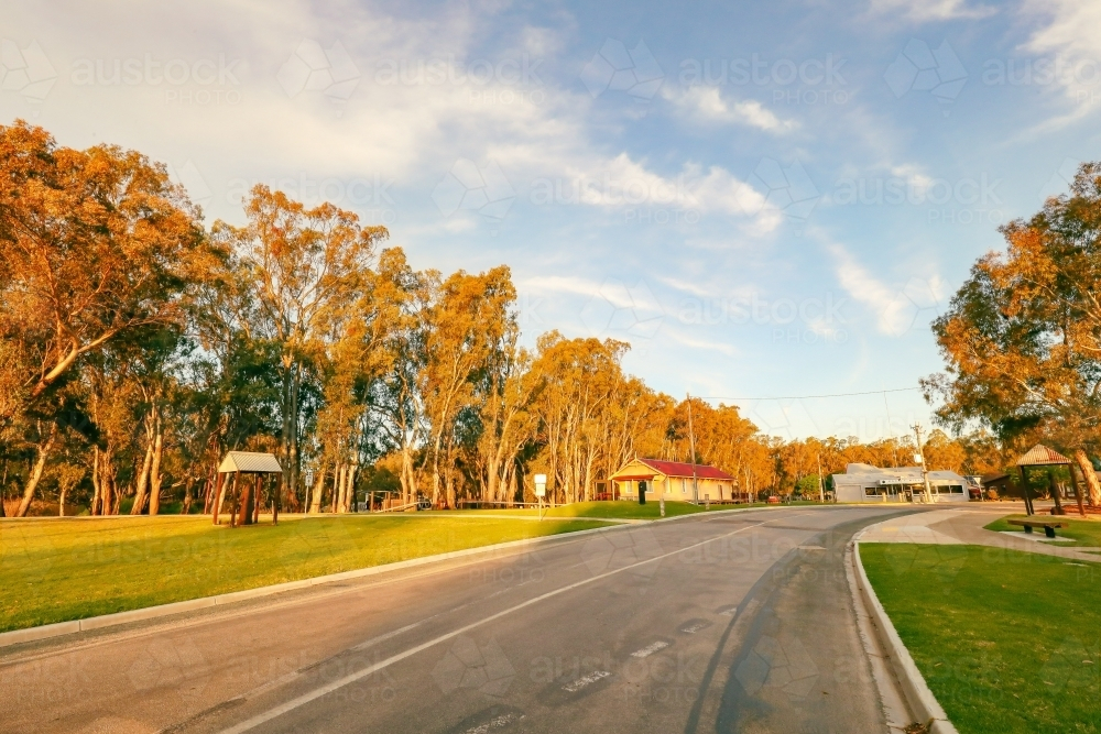 Street leading to old railway goods shed at Koondrook in golden afternoon sunlight - Australian Stock Image