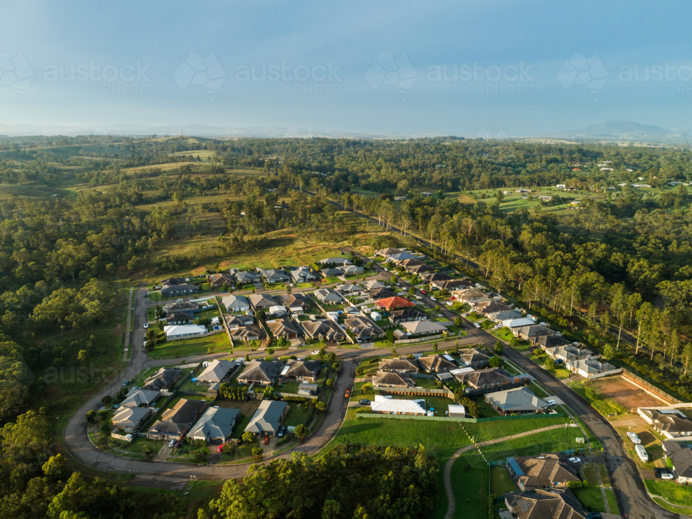 Streets and houses in new suburb at the edge of country town after rain from aerial perspective - Australian Stock Image